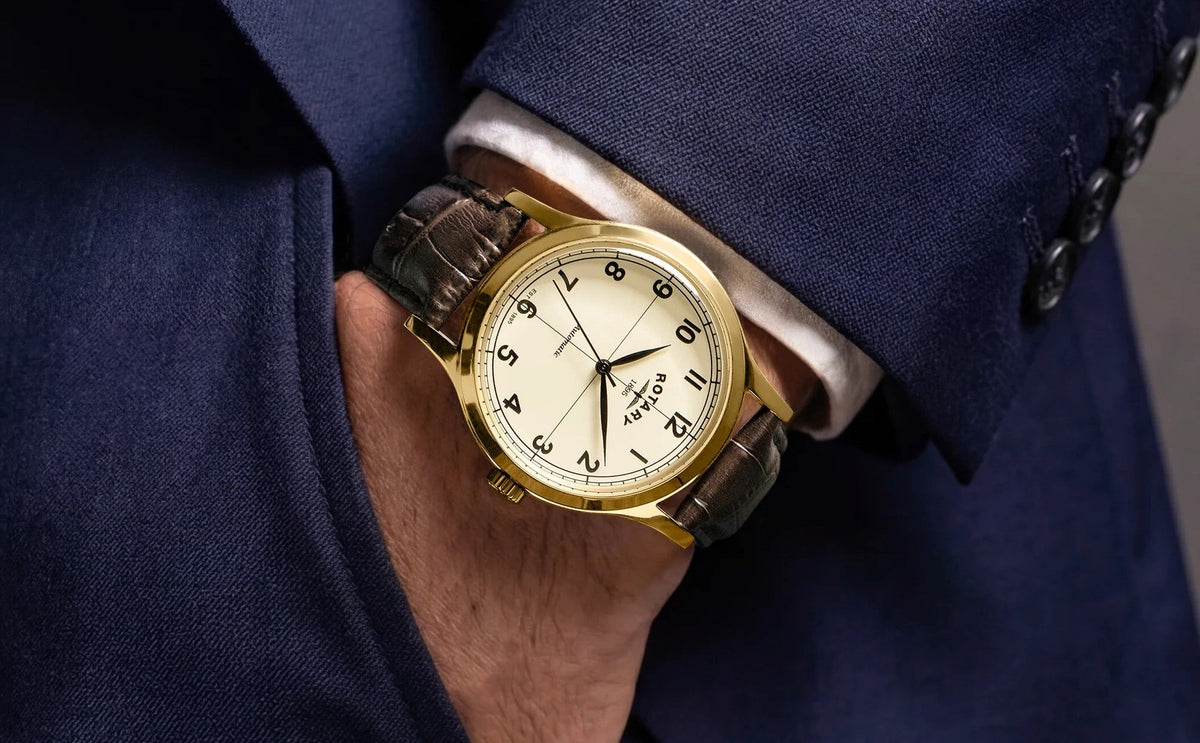 Model wears Rotary 1895 Automatic, Champagne Dial with Brown Leather Strap