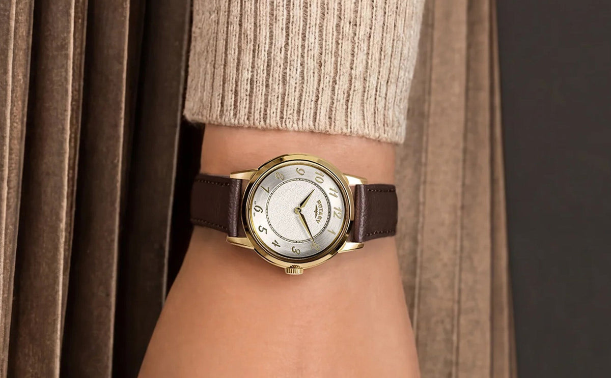 Model wears Rotary Heritage Ladies Gold Plated, White Dial with Brown Leather Strap