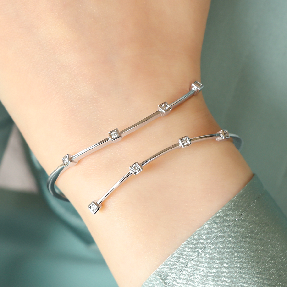 Model wears 18ct White Gold Diamond Crossover Hinged Bangle
