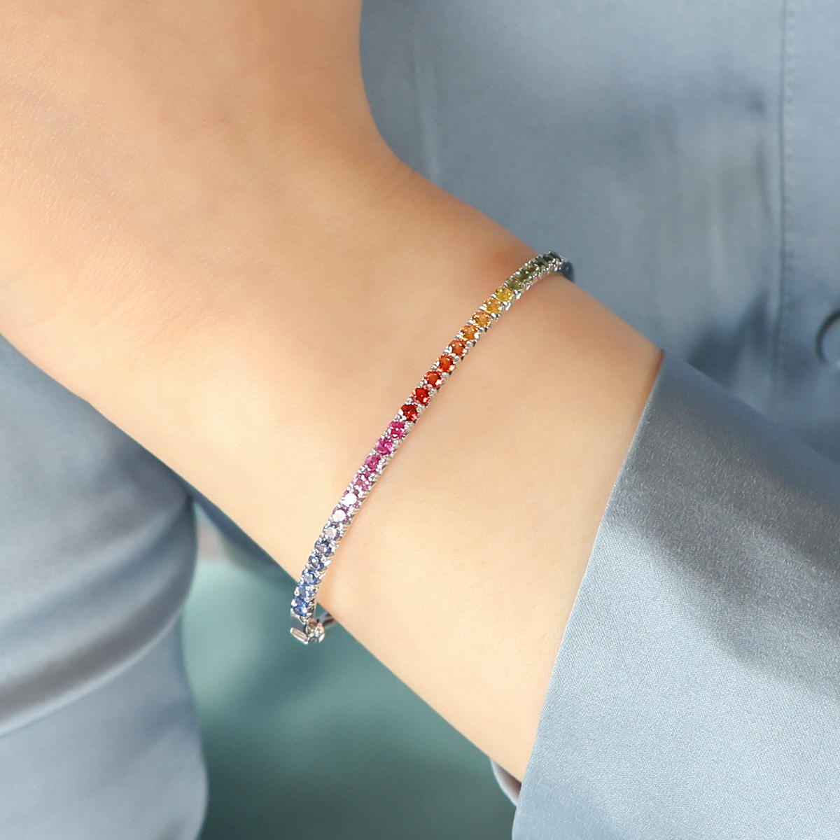 Model wears 18ct White Gold Fancy Sapphire Rainbow Bangle