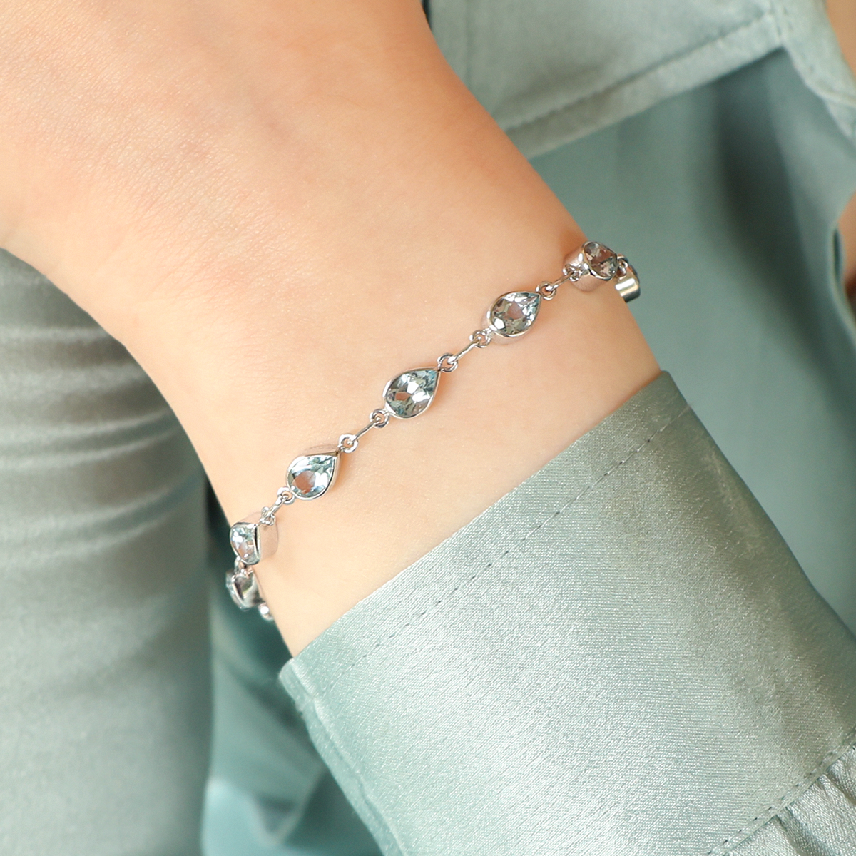 Model wears 9ct White Gold Teardrop Aquamarine Set Bracelet