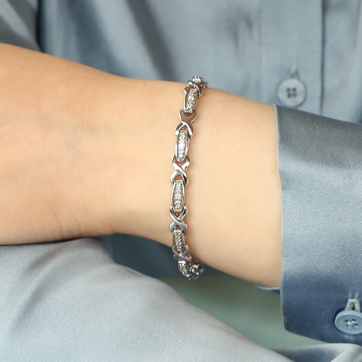 Model wears 9ct White Gold Diamond Set Log & Kiss Link Bracelet