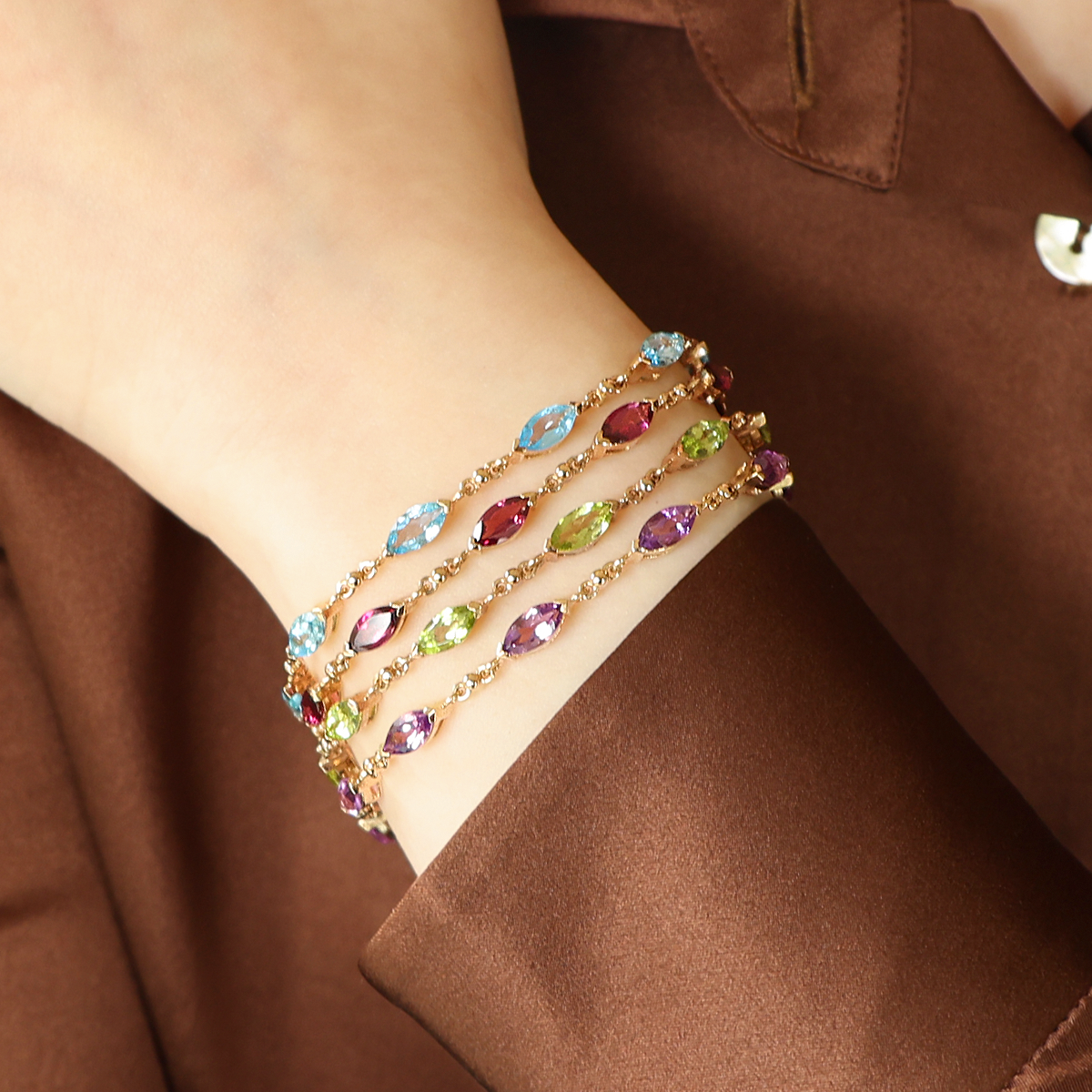 Model wears 9ct Yellow Gold Marquise Shaped Blue Topaz, Rhodolite Garnet, Peridot & Amethyst Bracelets