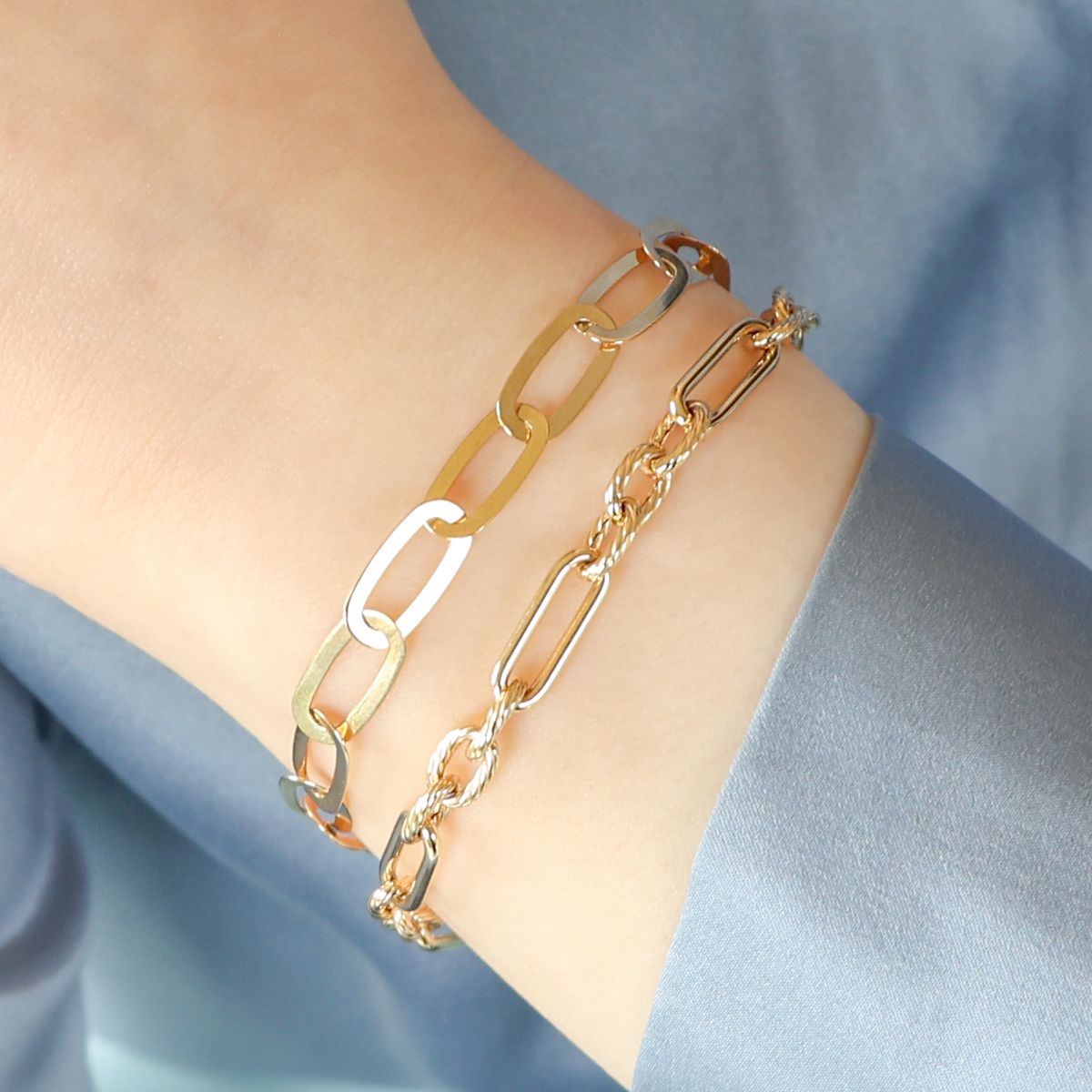Model wears 9ct Yellow Gold Elongated Flat Oval Link Bracelet & 9ct Yellow Gold Polished & Twisted Oval Link Bracelet