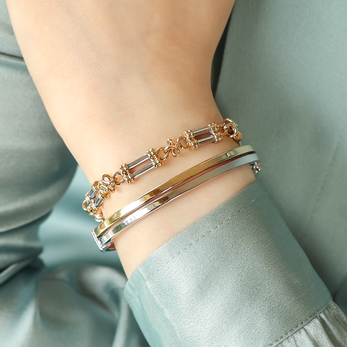 Model wears 9ct Yellow & White Gold Double Bar & Knot Link Bracelet & 9ct Two Colour Gold Double Band Tension Bangle