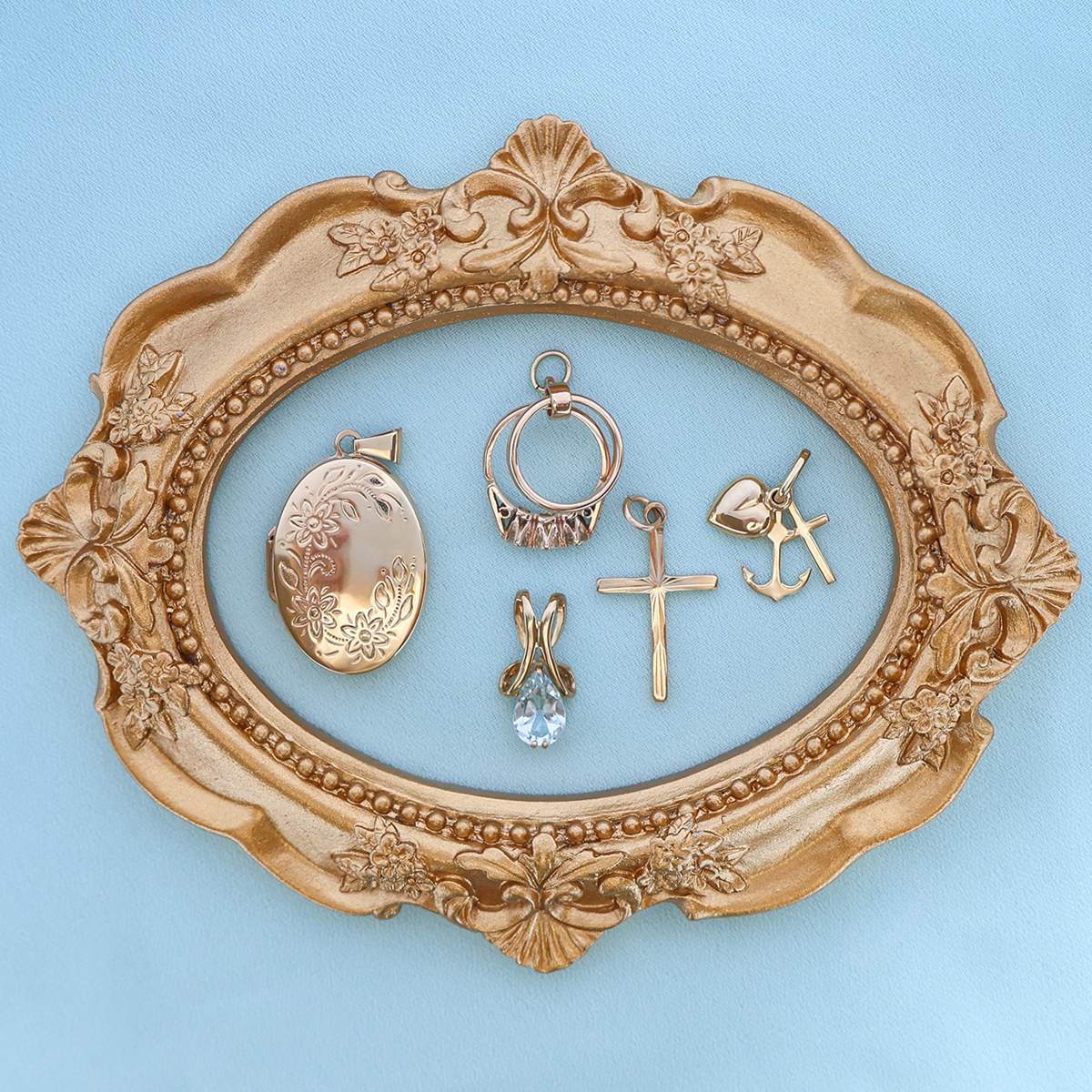 9ct Yellow Gold Oval Shaped Floral Locket, 9ct Yellow Gold Trilogy & Wedding Rings Charm By Georg Jensen, 9ct Yellow Gold Pear Shaped Aquamarine Ribbon Pendant, 9ct Yellow Gold Diamond Cut Cross Pendant By Georg Jensen & 9ct Yellow Gold Faith, Hope & Charity Pendant