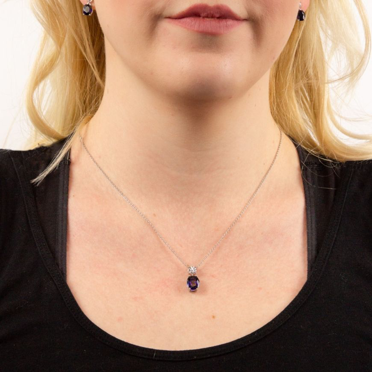Model wears Sterling Silver Oval Shaped Blue Cubic Zirconia Drop Pendant & Chain