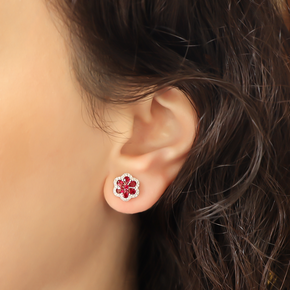 Model wears 18ct White Gold Ruby & Diamond Flower Stud Earrings