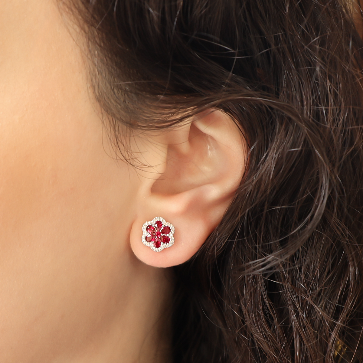 Model wears 18ct White Gold Ruby & Diamond Flower Stud Earrings