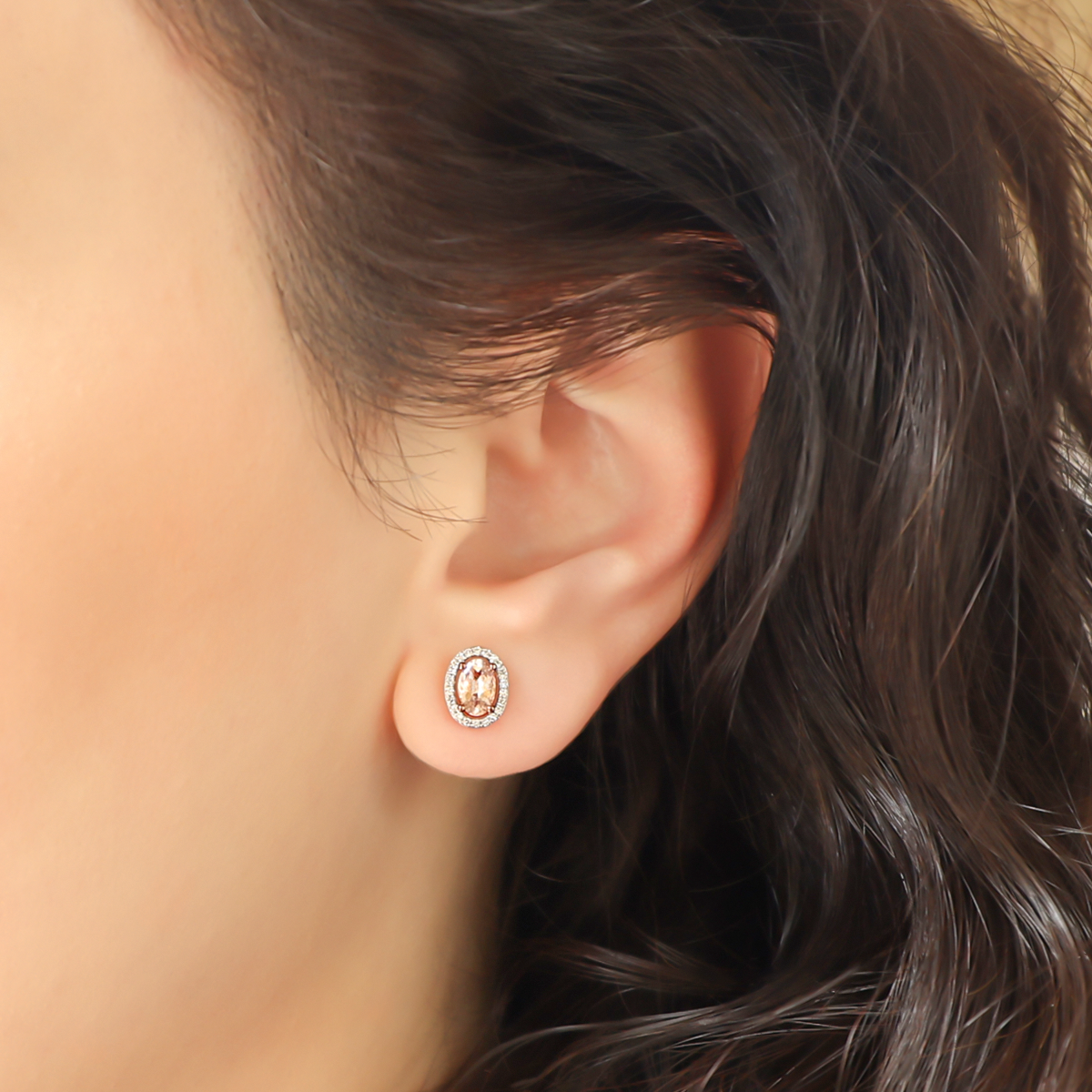 Model wears 9ct Rose Gold Oval Morganite & Diamond Halo Cluster Stud Earrings