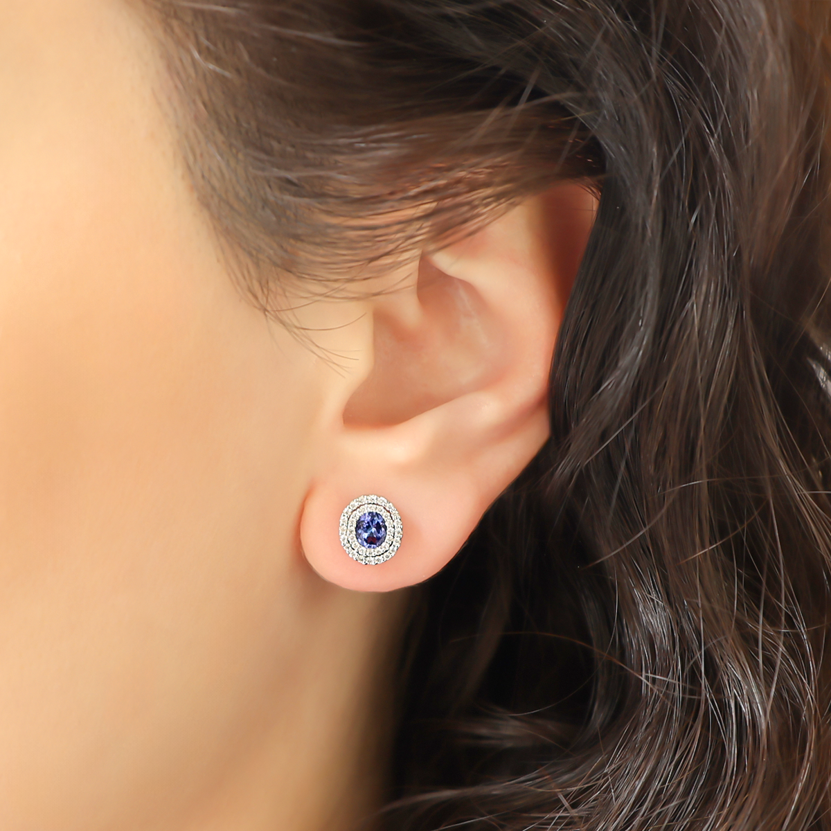 Model wears 9ct White Gold Oval Tanzanite & Diamond Double Halo Stud Earrings