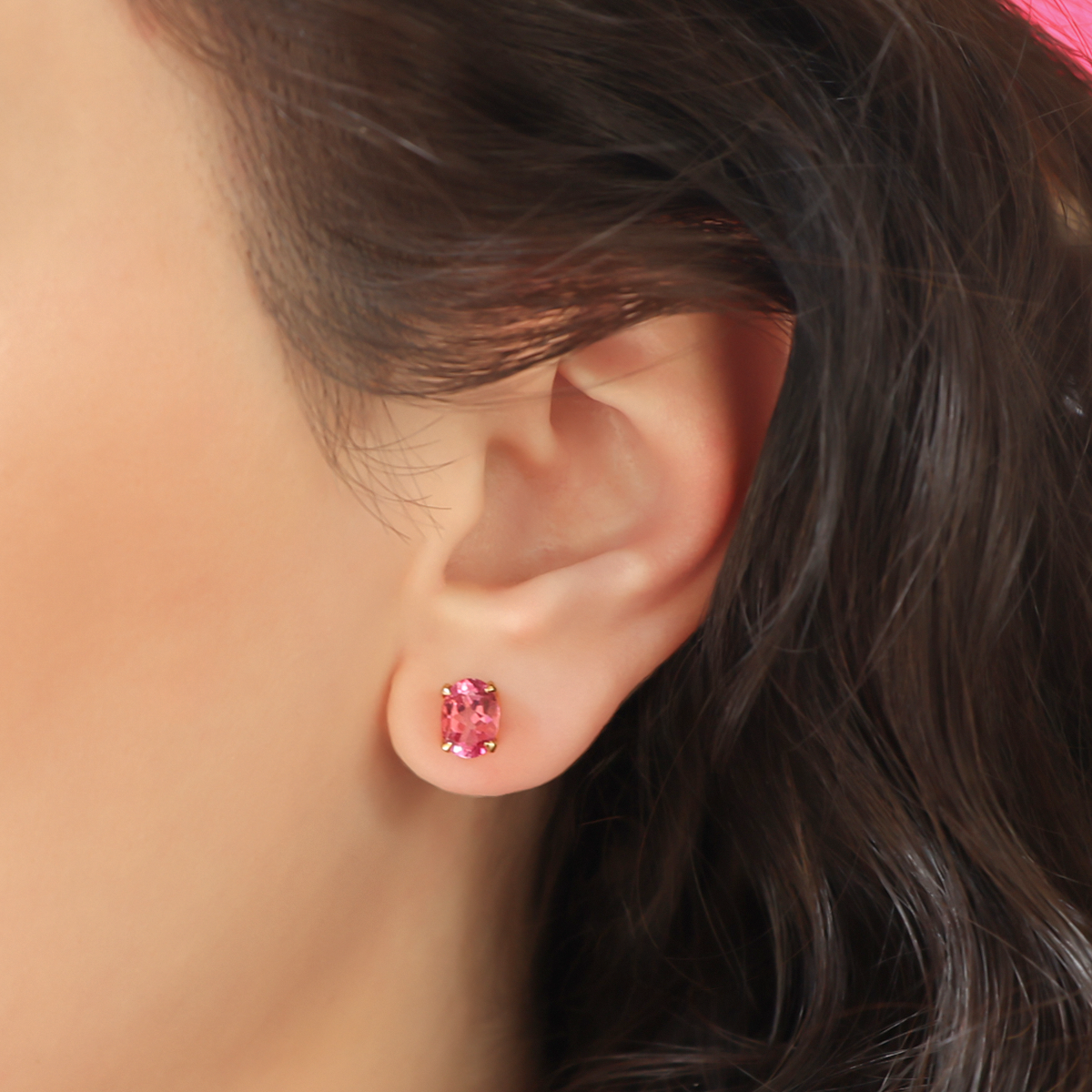 Model wears 9ct Yellow Gold Oval Shaped Pink Topaz Claw Set Stud Earrings