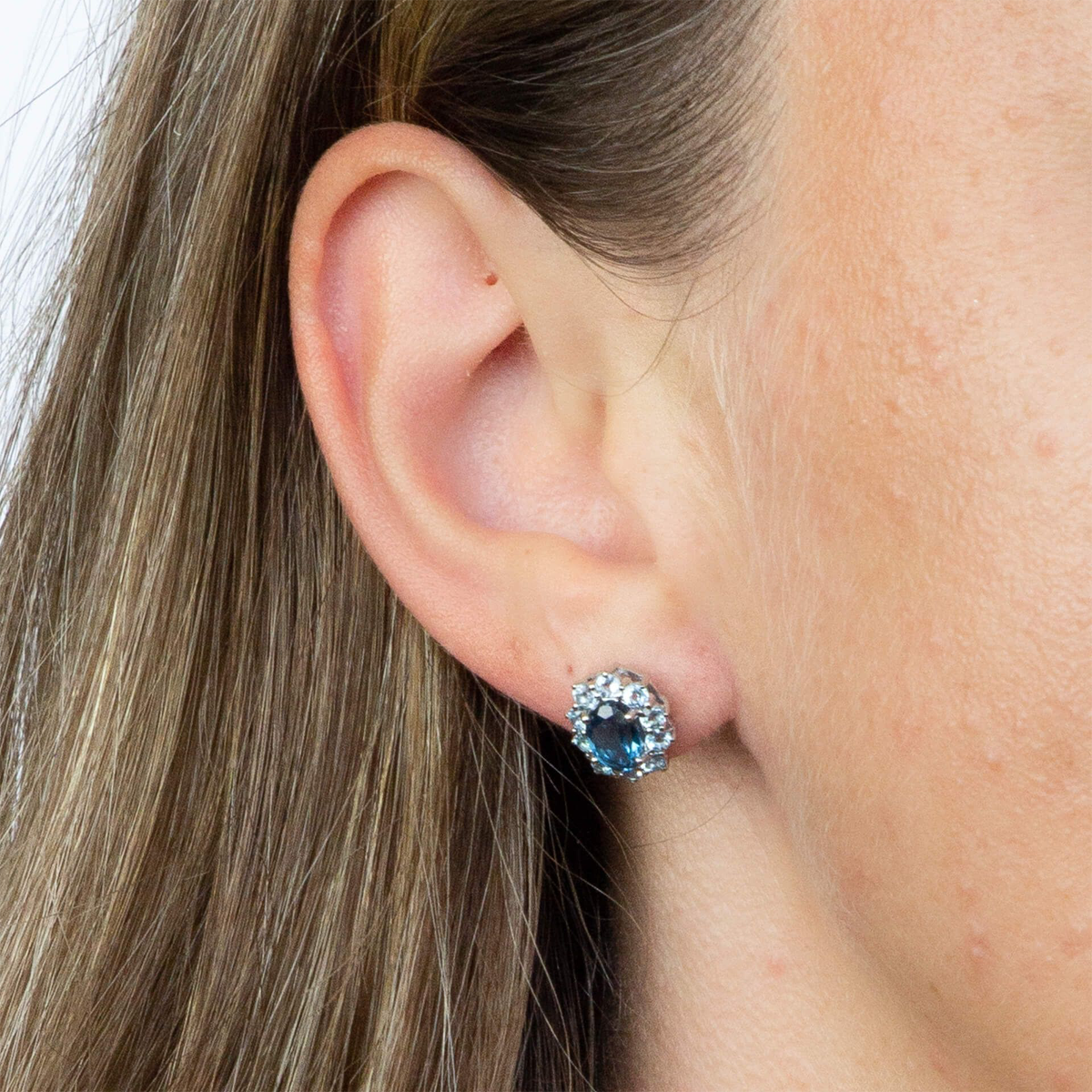 Model wears 9ct White Gold Blue Topaz Cluster Stud Earrings