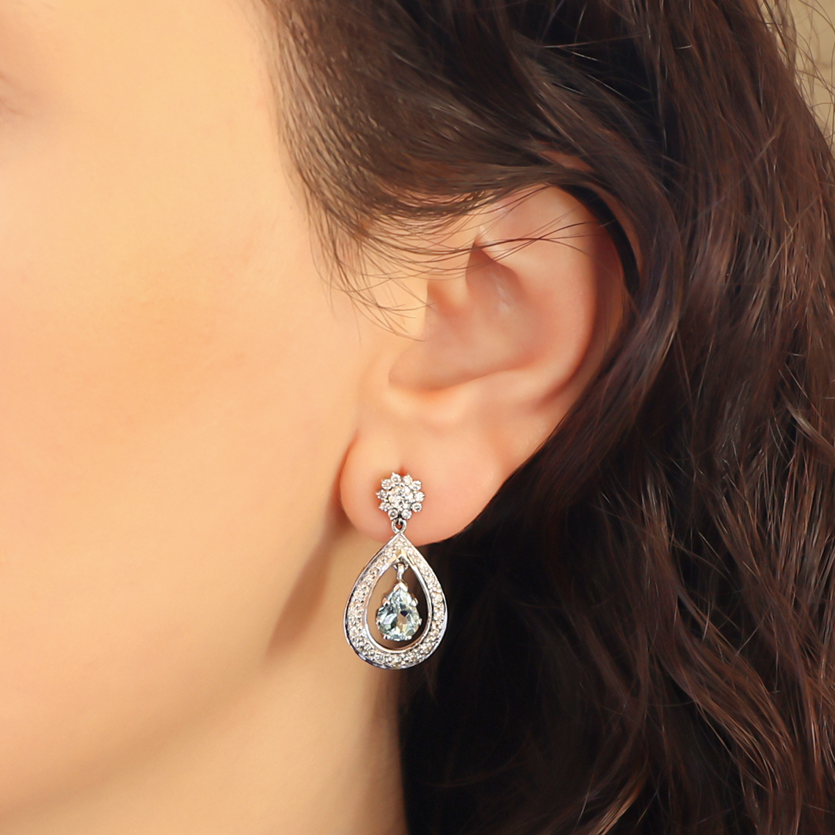 Model wears 18ct White Gold Aquamarine & Diamond Pear Shaped Drop Earrings