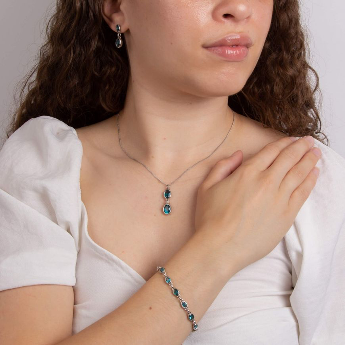 Model wears Sterling Silver Aqua Nano Crystal Drop Pendant & Chain, Earrings & Bracelet