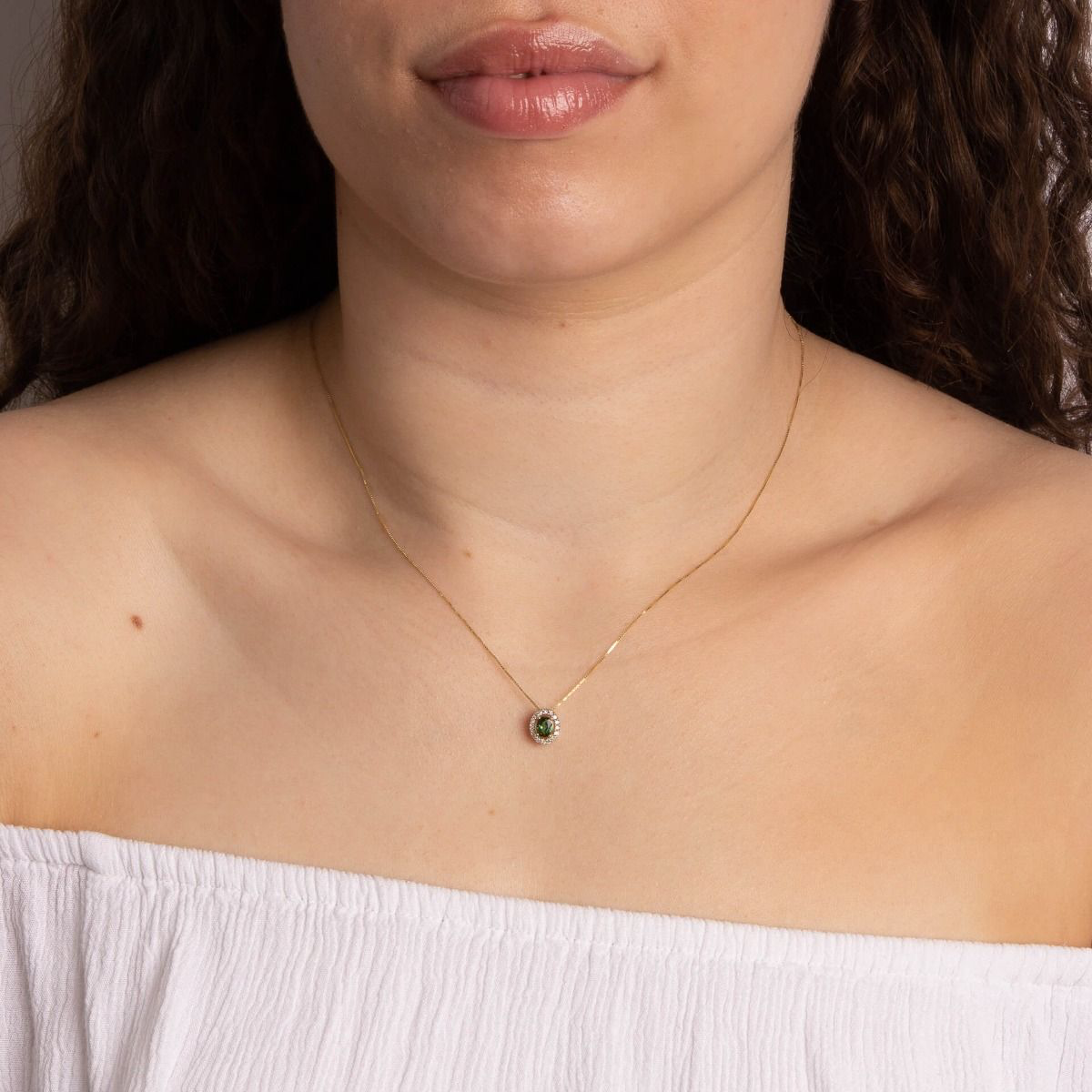 Model wears 9ct Yellow Gold Green Tourmaline & Diamond Halo Pendant