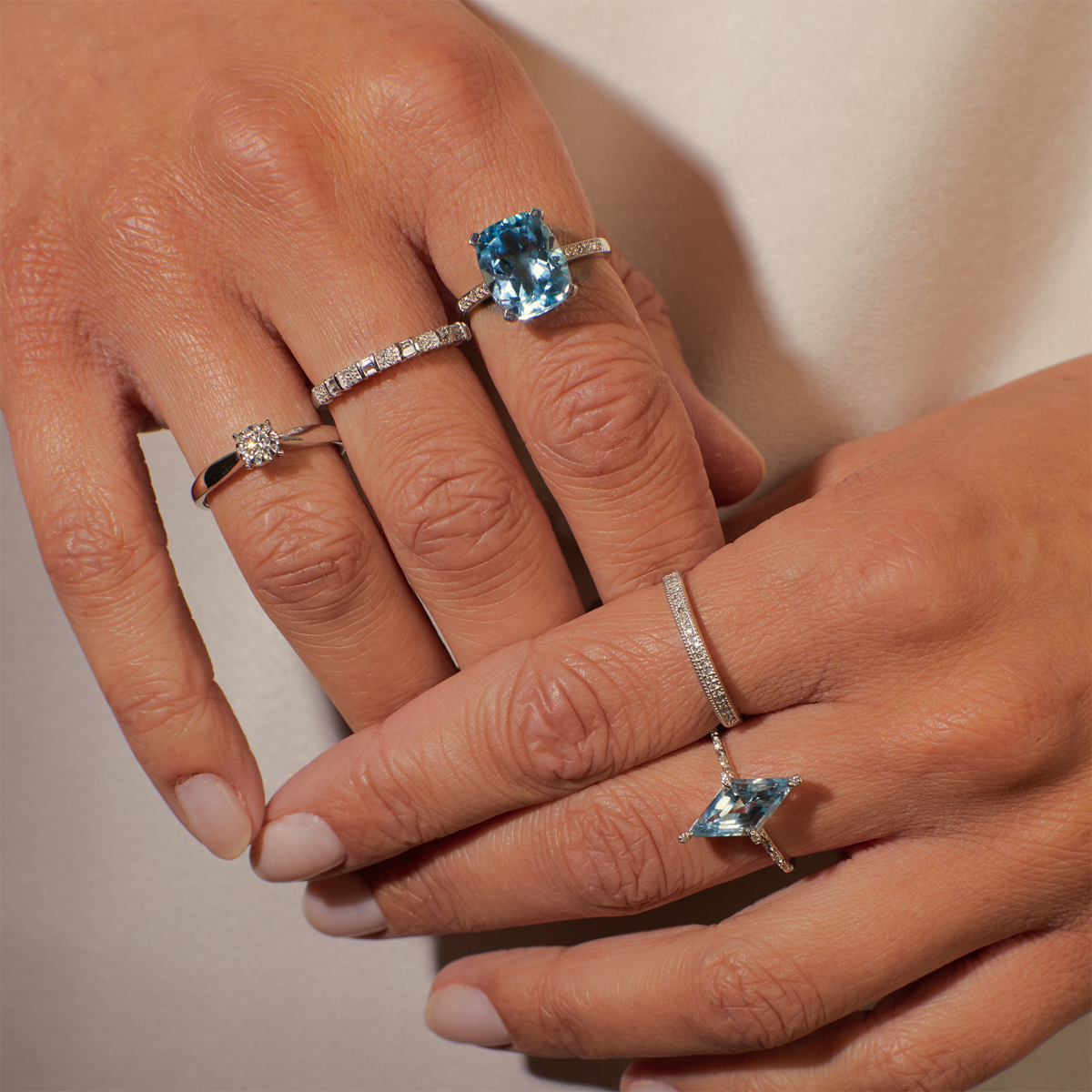 Model wears 9ct White Gold Cushion Shaped Sky Blue Topaz & Diamond Cocktail Ring