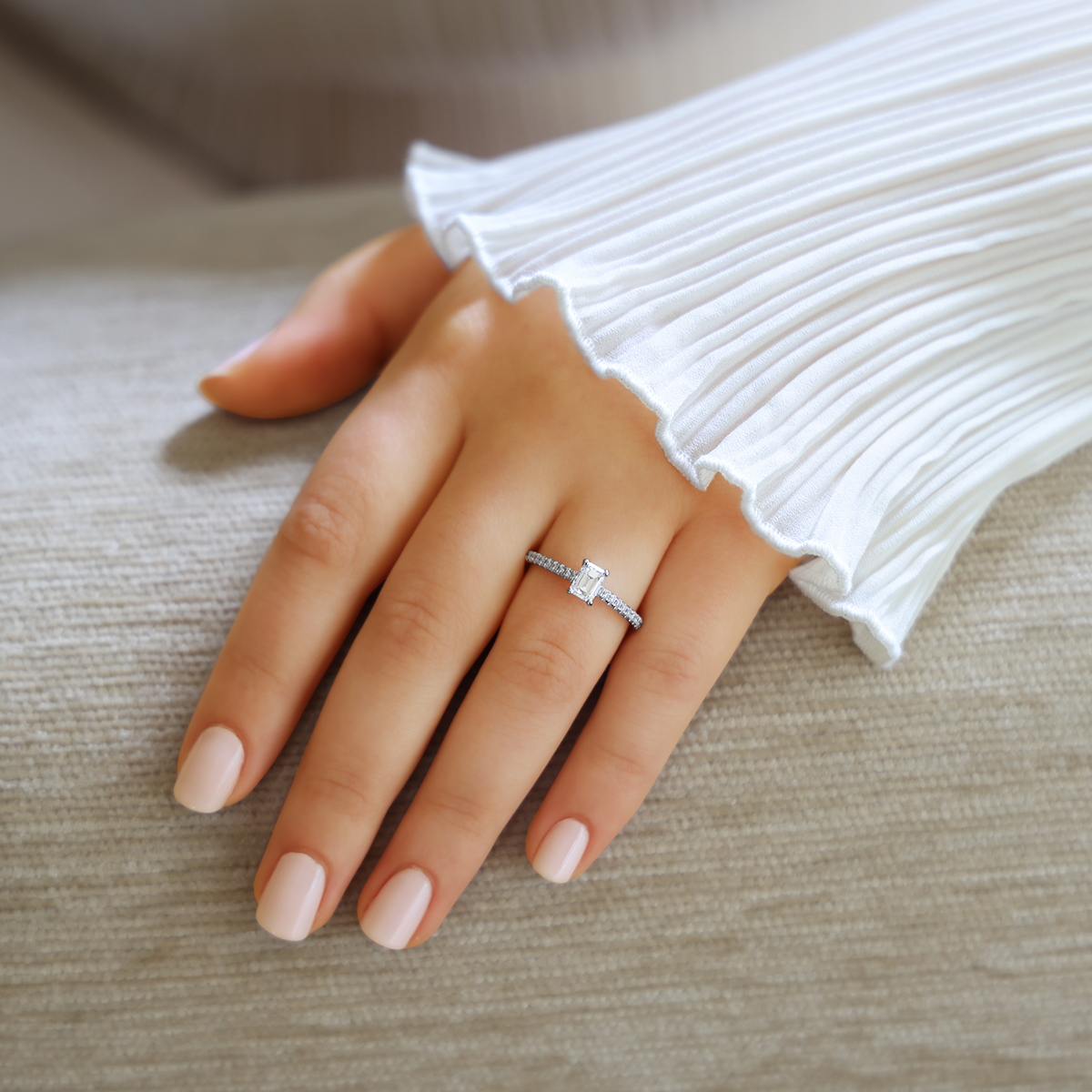 Model wears Platinum Emerald Cut Diamond Solitaire & Shoulder 0.77ctw Ring