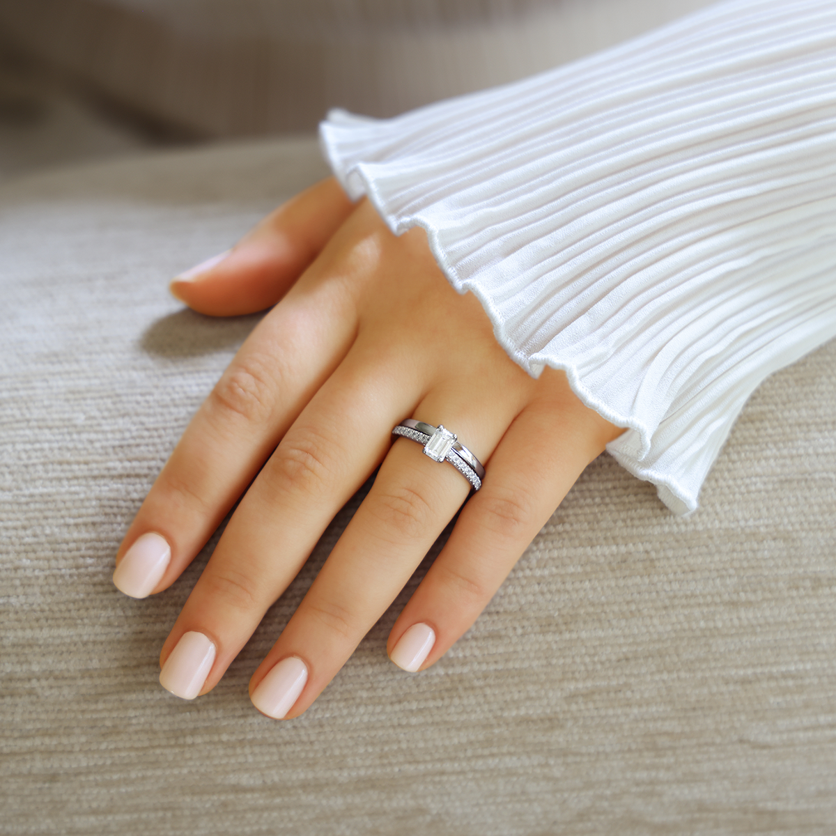 Model wears Platinum Emerald Cut Diamond Solitaire & Shoulder 1.06ctw Ring with Wedding Band