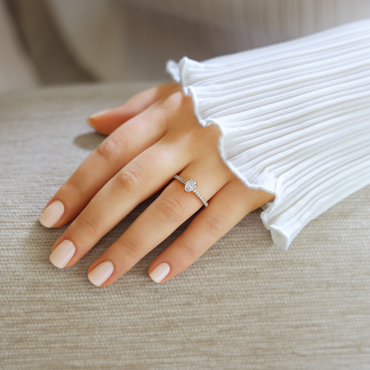 Model wears 18ct Yellow Gold Pear Cut Diamond Solitaire & Shoulder 0.84ctw Ring