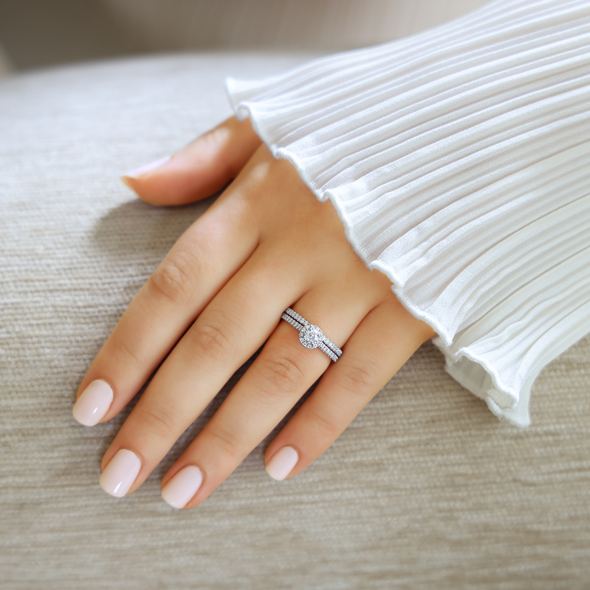 Model wears Platinum Round Shaped Diamond Halo & Shoulder 0.50ctw Ring with Matching Eternity Ring