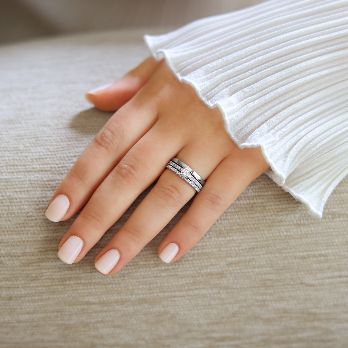 Model wears Platinum Round Brilliant Cut Diamond Solitaire & Shoulder 0.52ctw Ring with Matching Eternity & Wedding Band