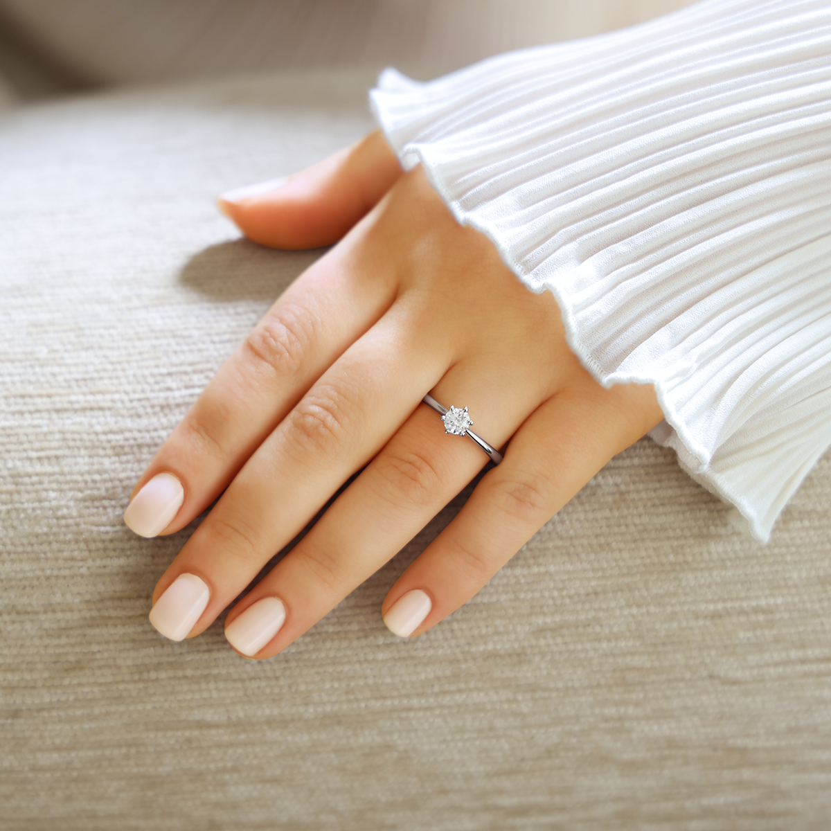 Model wears Platinum Round Brilliant Cut Diamond Solitaire 0.57ct Ring