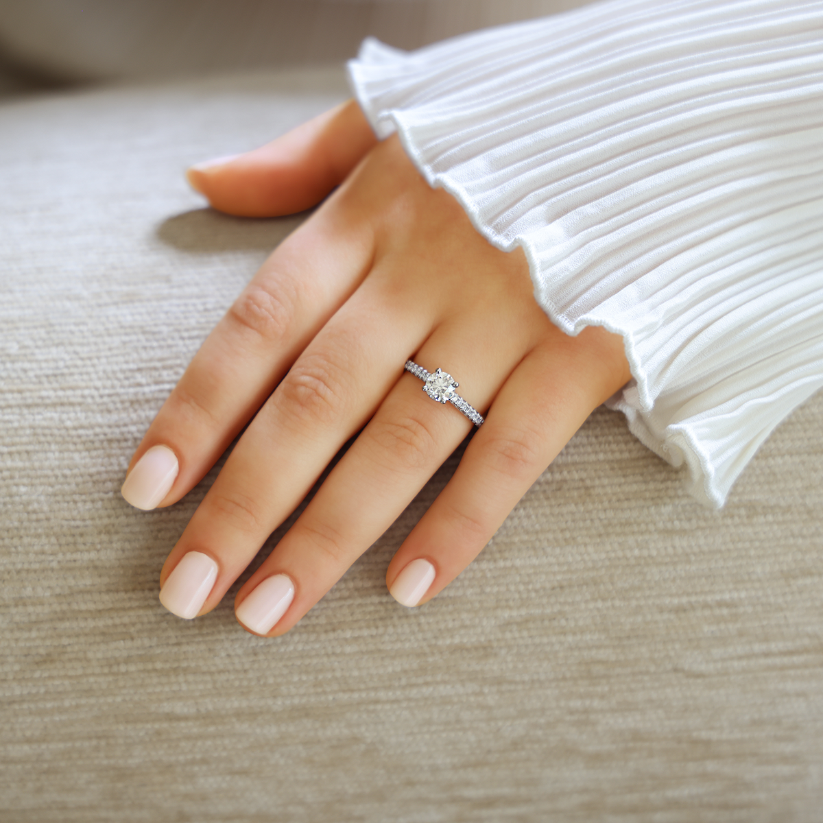 Model wears Platinum Round Brilliant Cut Diamond Solitaire & Shoulder 1.08ctw Ring