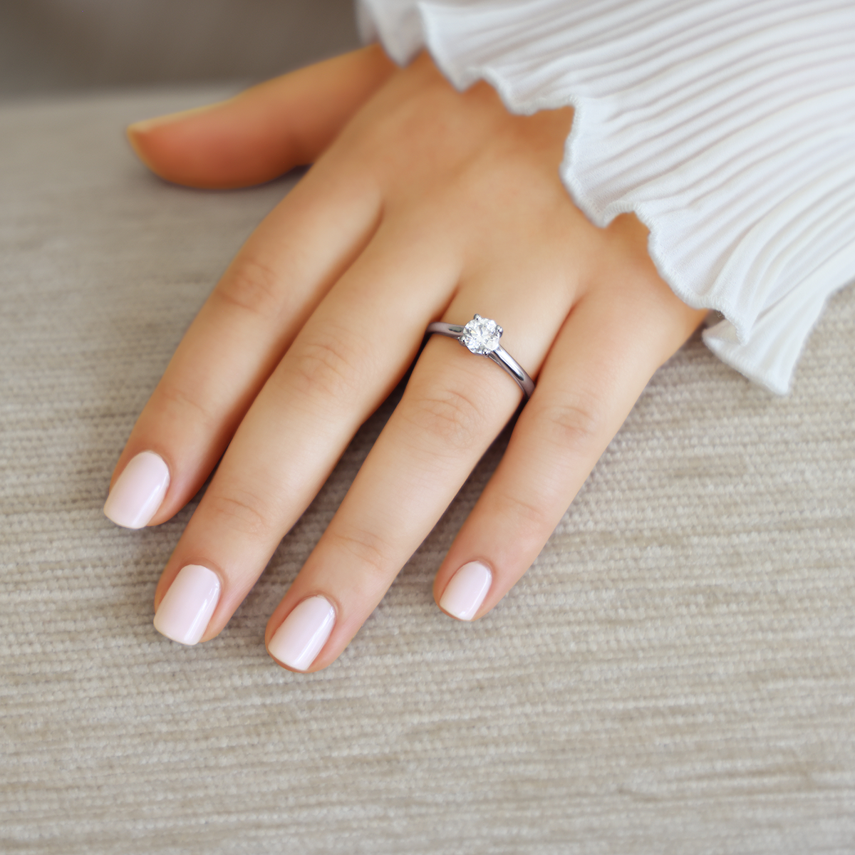 Model wears Platinum Round Brilliant Cut Diamond Solitaire 1.00ct Ring