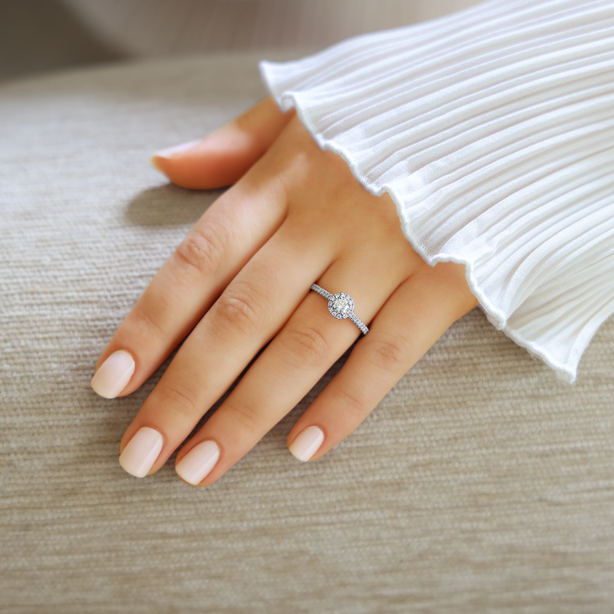 Model wears Platinum Round Shaped Diamond Halo & Shoulder 0.61ctw Ring