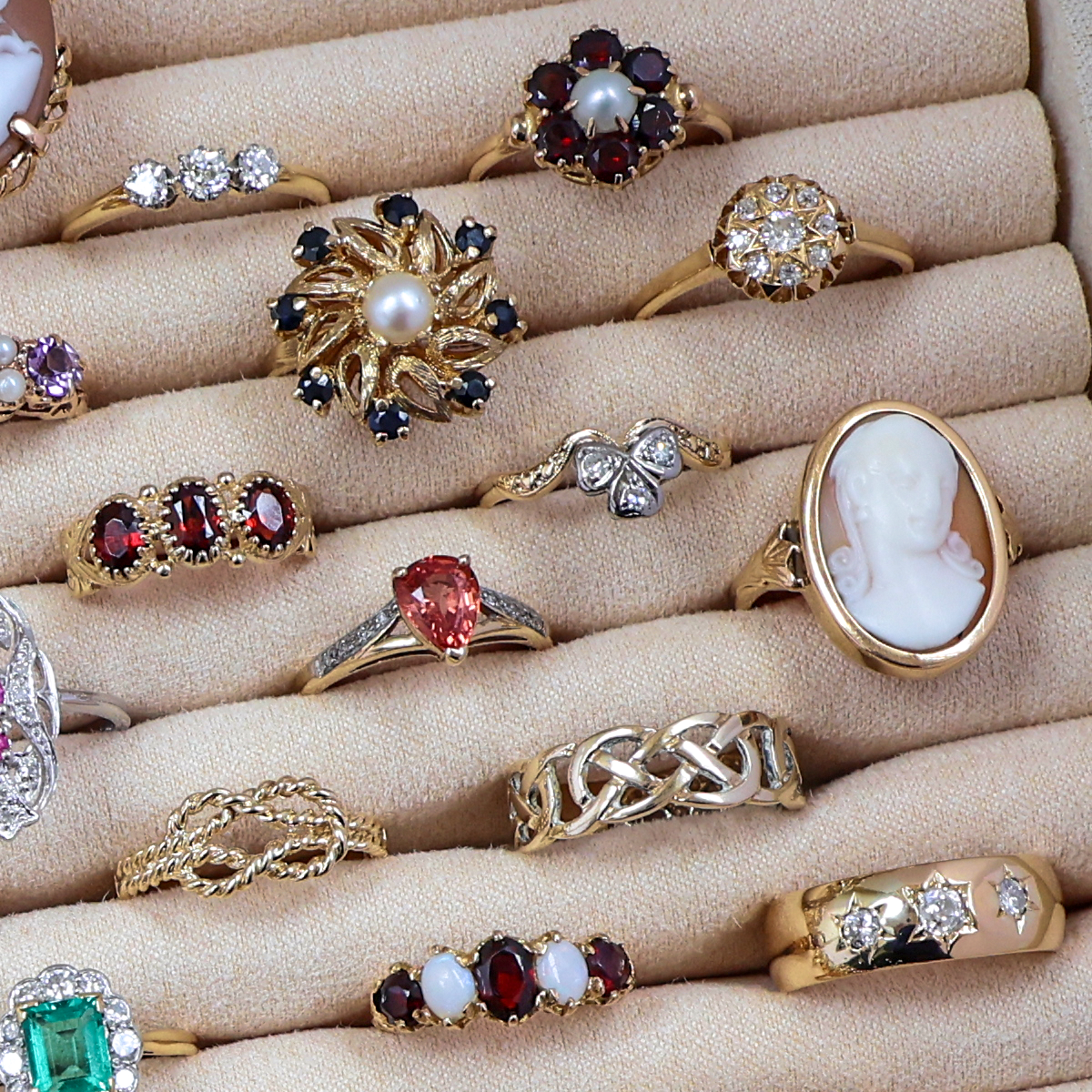 A selection of Estate, Vintage or Antique gold rings set with precious gemstones and crafted with intricate motifs.
