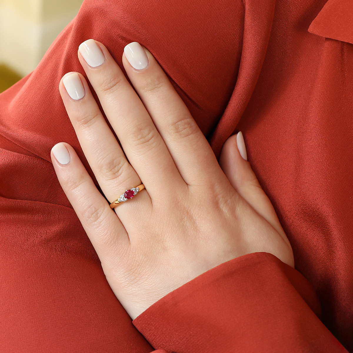 Model wears 18ct Yellow Oval Shaped Ruby & Diamond Seven Stone Ring