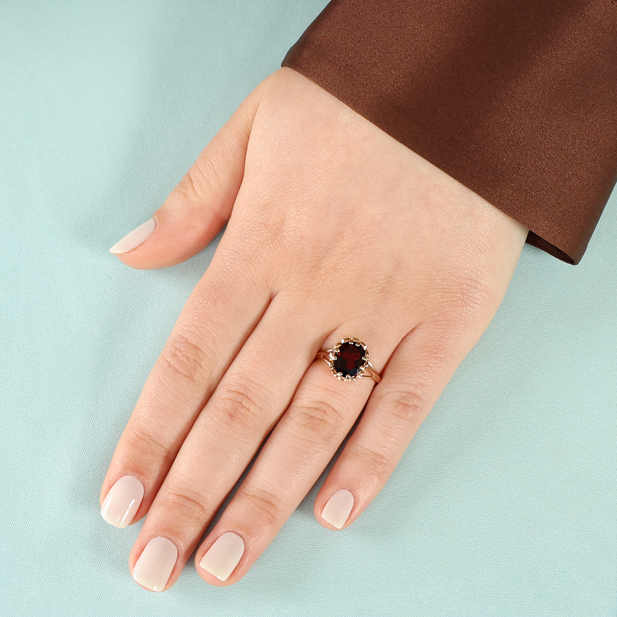 Model wears 9ct Yellow Gold Garnet Lotus Solitaire Ring