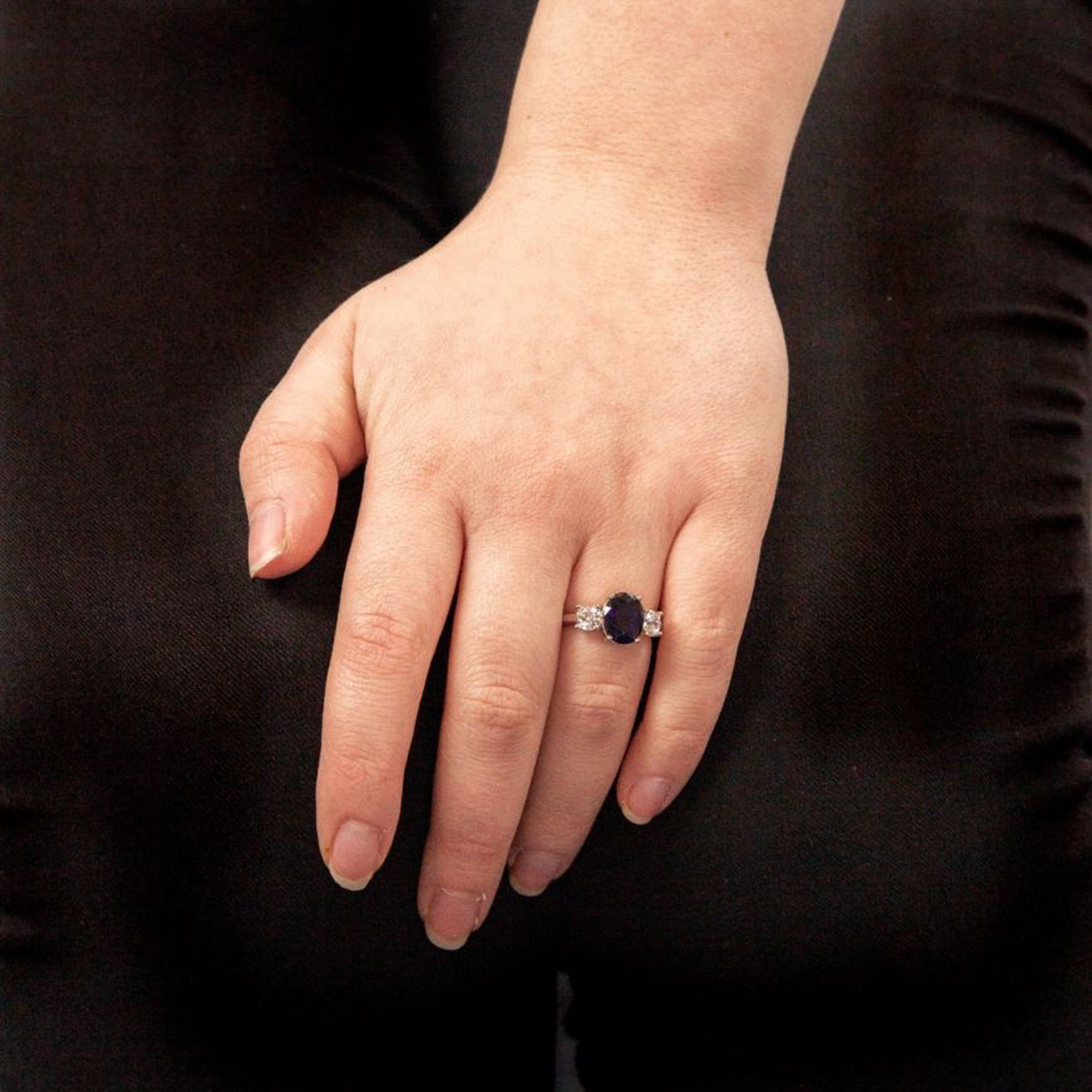 Model wears Sterling Silver Oval Blue Cubic Zirconia Trilogy Ring