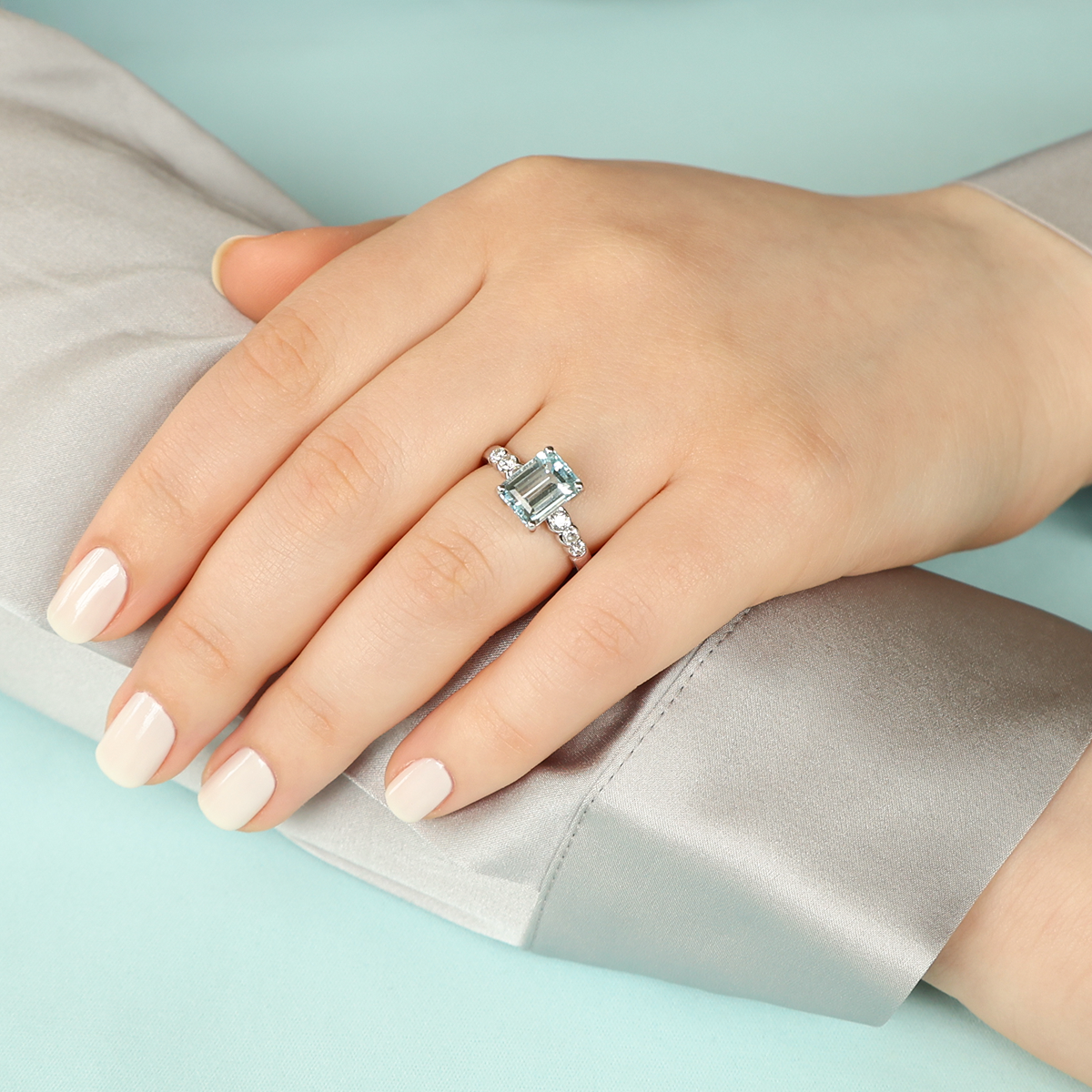 Model wears 18ct White Gold Emerald Cut Aquamarine & Diamond Solitaire Ring