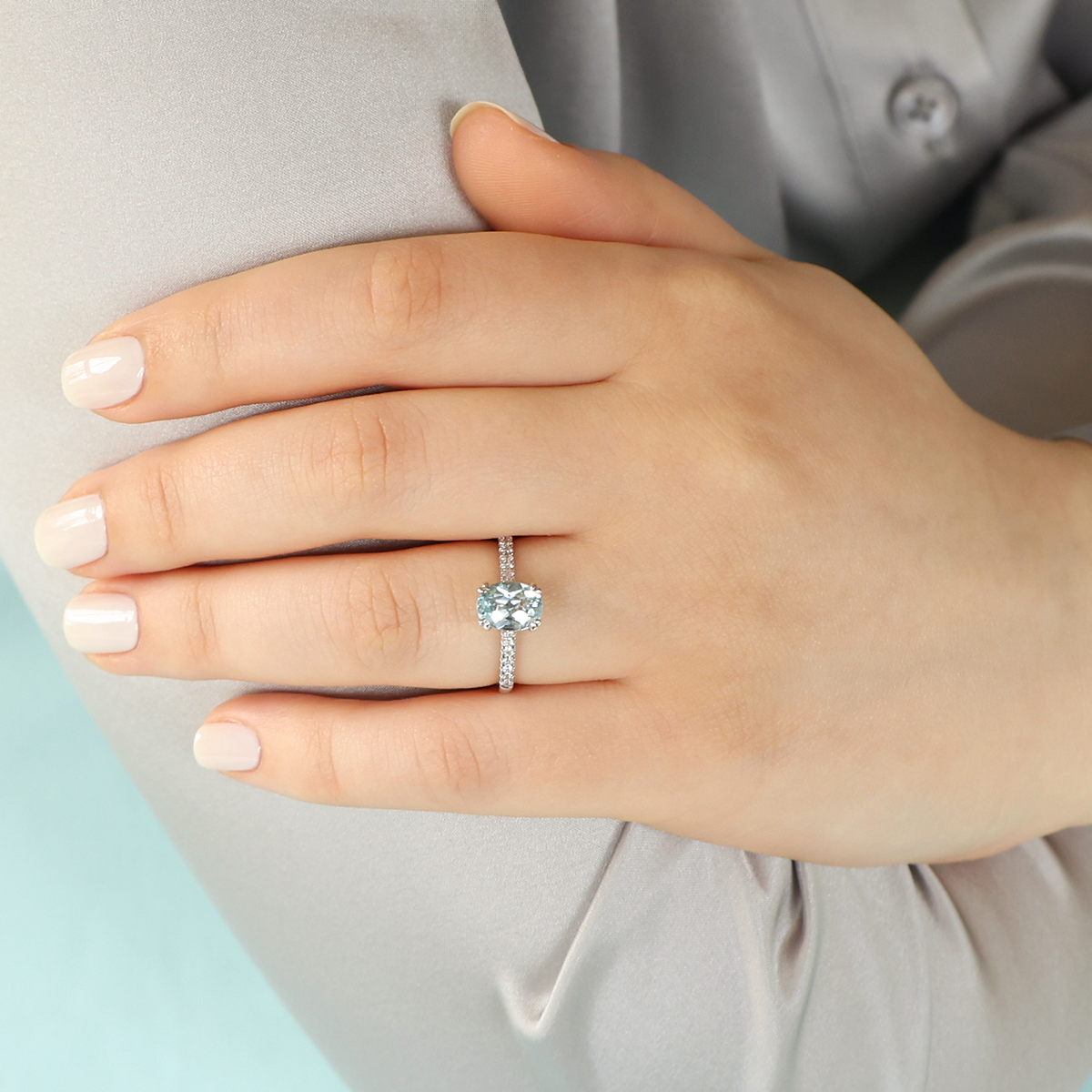 Model wears 9ct White Gold Oval Cut Aquamarine & Diamond Solitaire Ring