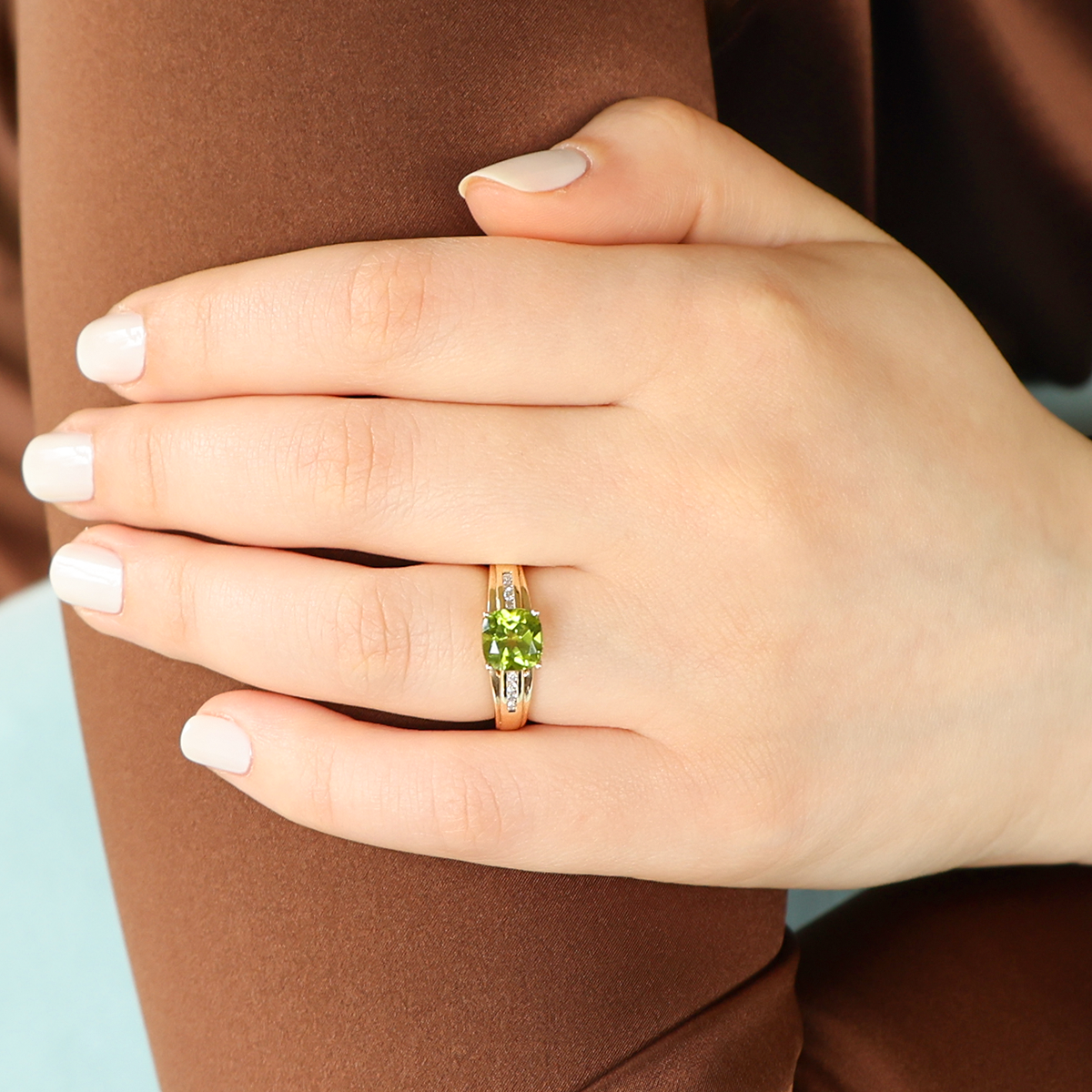 Model wears 9ct Yellow Gold Cushion Cut Peridot & Diamond Ring
