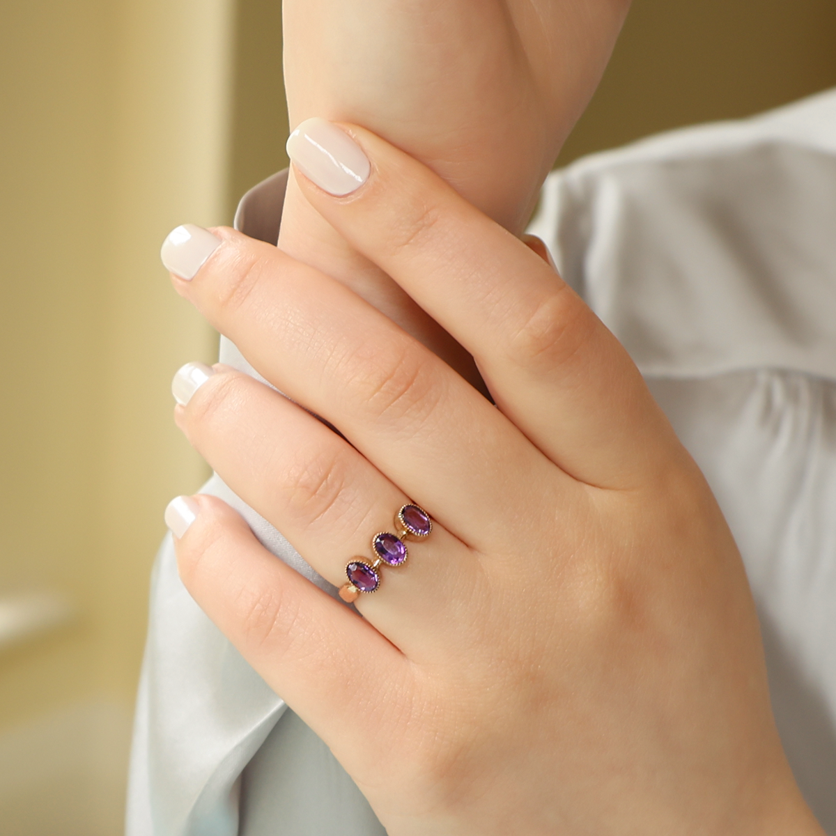 Model wears 9ct Rose Gold Oval Shaped Amethyst Trilogy Edwardian Ring