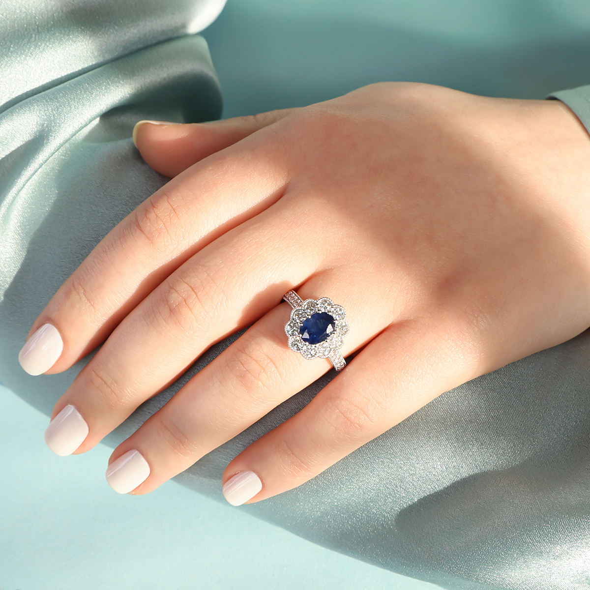 Model wears Model wears 18ct White Gold Oval Cut Sapphire & Diamond Cluster Ring