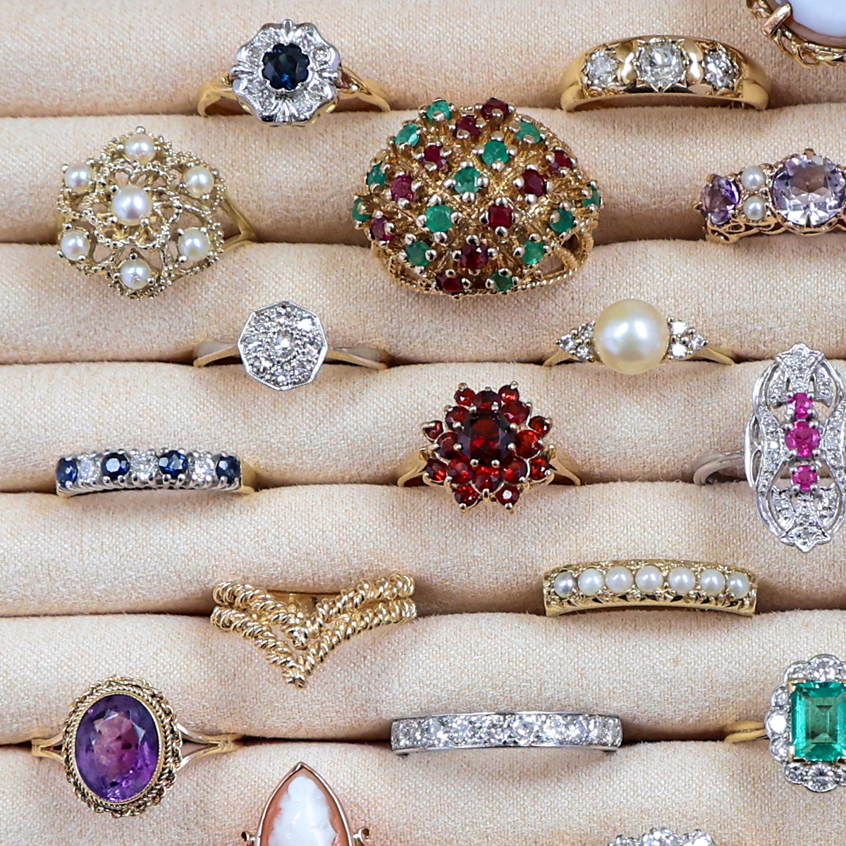 A selection of Estate, Vintage or Antique gold rings set with precious gemstones and crafted with intricate motifs.