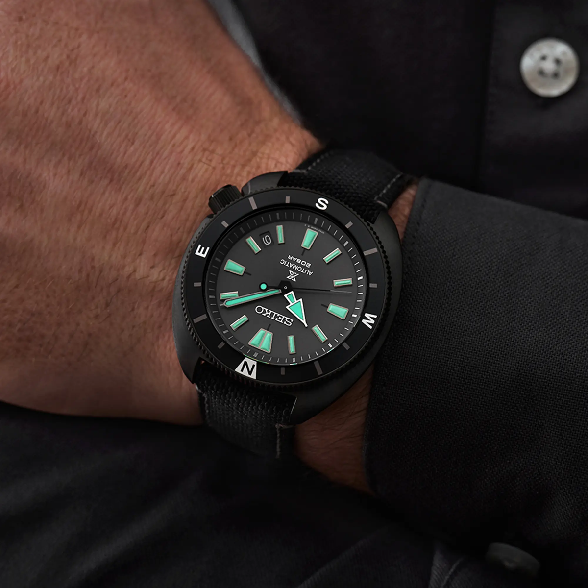 Model wears Prospex 'Black Series’ Tortoise Automatic, Black Bezel with Black Polyester Strap - SRPH99K1