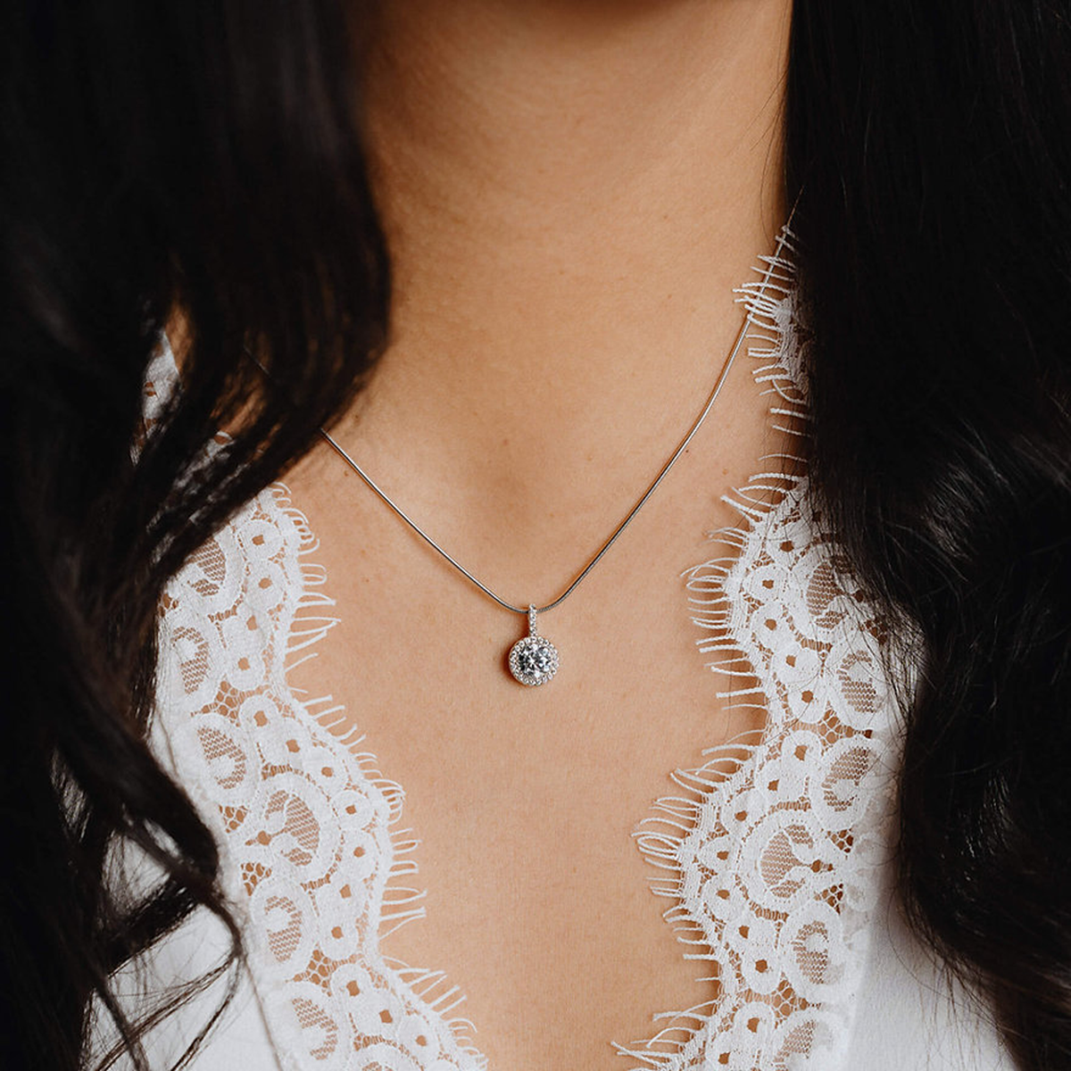 Model wears Sterling Silver Round Cubic Zirconia Halo Pendant & Chain