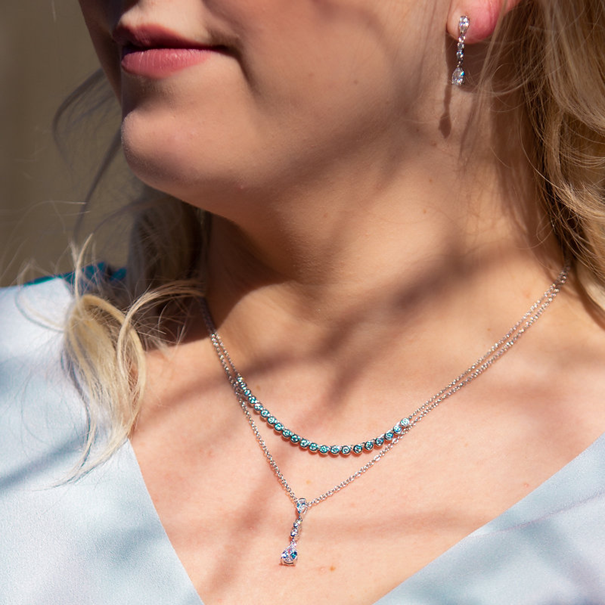 Model wears Sterling Silver Long Teardrop Cubic Zirconia Pendant & Earrings