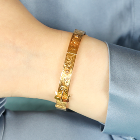 Model wears 9ct Yellow Gold Hollow Engraved Buckle Hinged Bangle