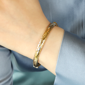 Model wears 9ct Yellow Gold 6.5mm Hollow Diamond Cut Hinged Bangle