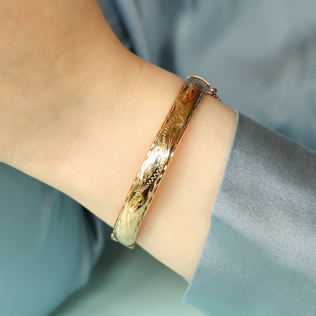 Model wears 9ct Yellow Gold 8.5mm Hollow Engraved Hinged Bangle