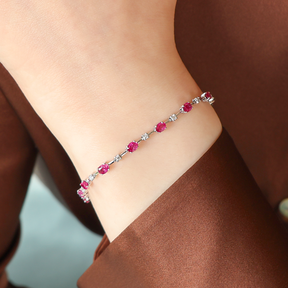 Model wears 18ct White Gold Oval Shaped Ruby & Diamond Set Bracelet