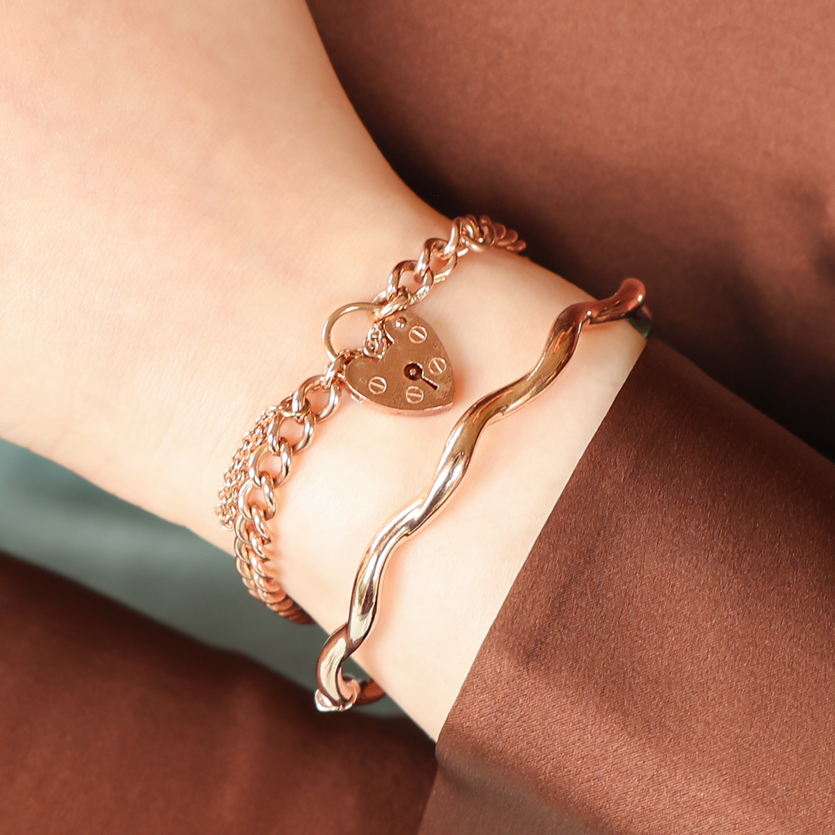 Model wears 9ct Rose Gold Curb Charm Bracelet & 9ct Rose Gold Wavy Hinged Bangle