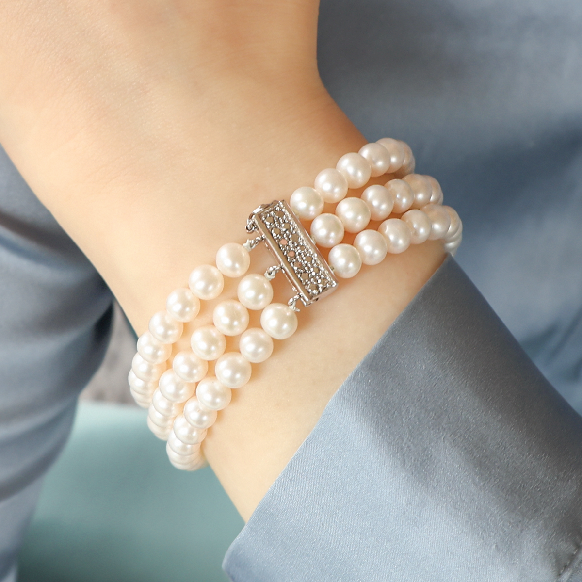 Model wears 9ct White Gold Cultured Freshwater Pearl Triple Strand Bracelet