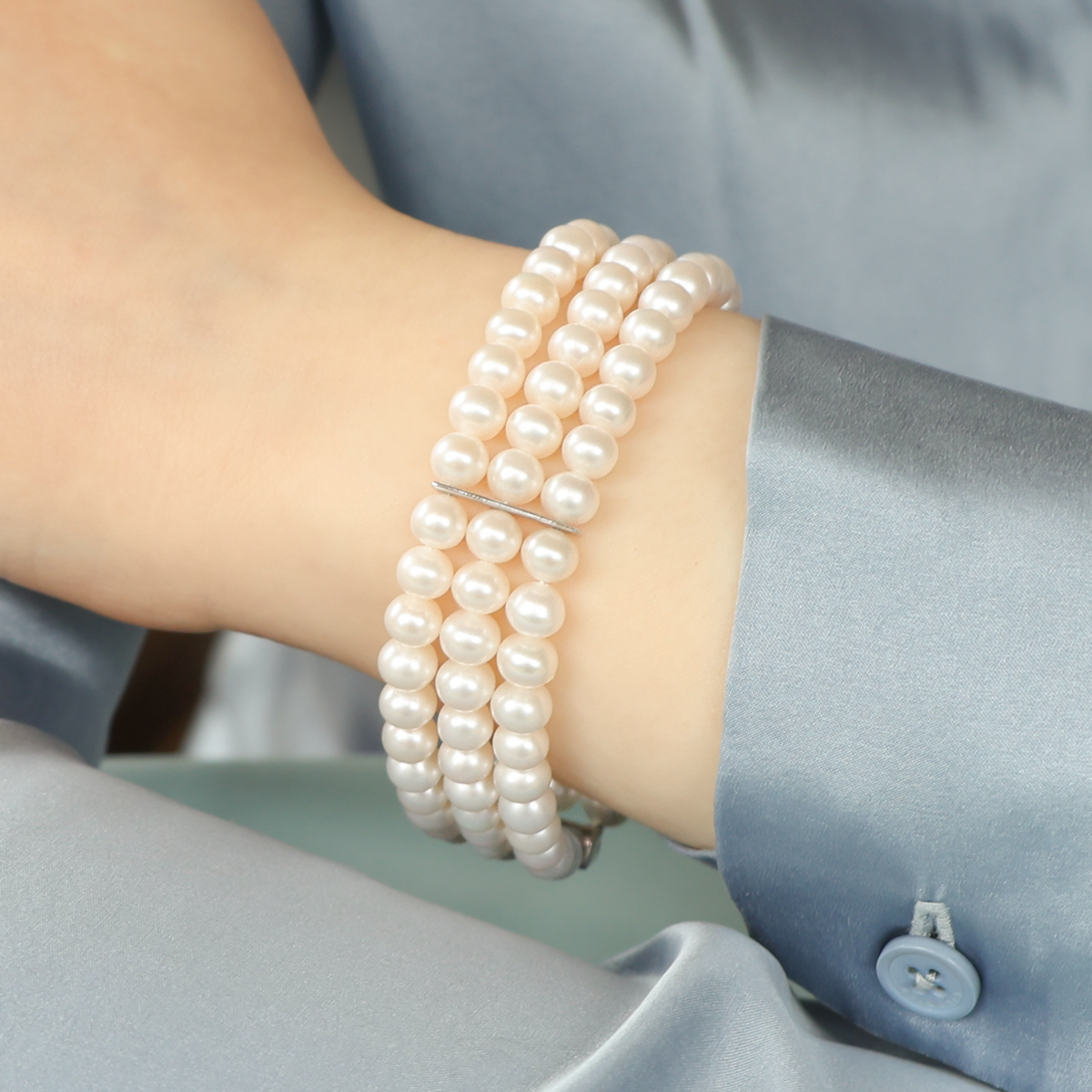 Model wears 9ct White Gold Cultured Freshwater Pearl Triple Strand Bracelet